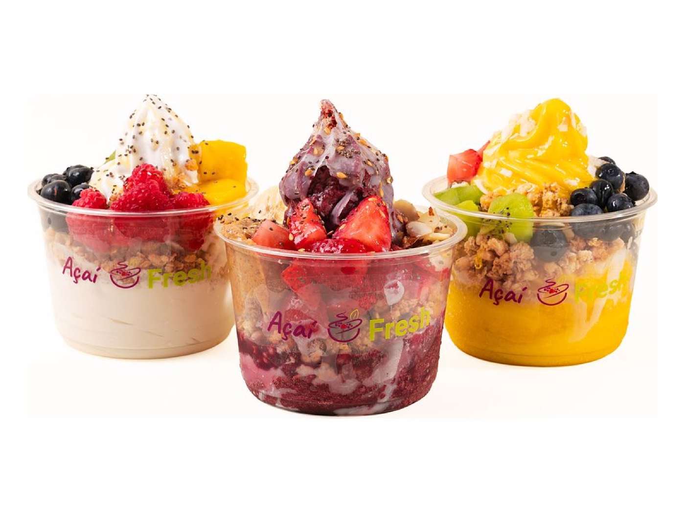 Three bowls side by side: an oat milk bowl, an açaí bowl and a mango bowl, each topped with fruit and granola